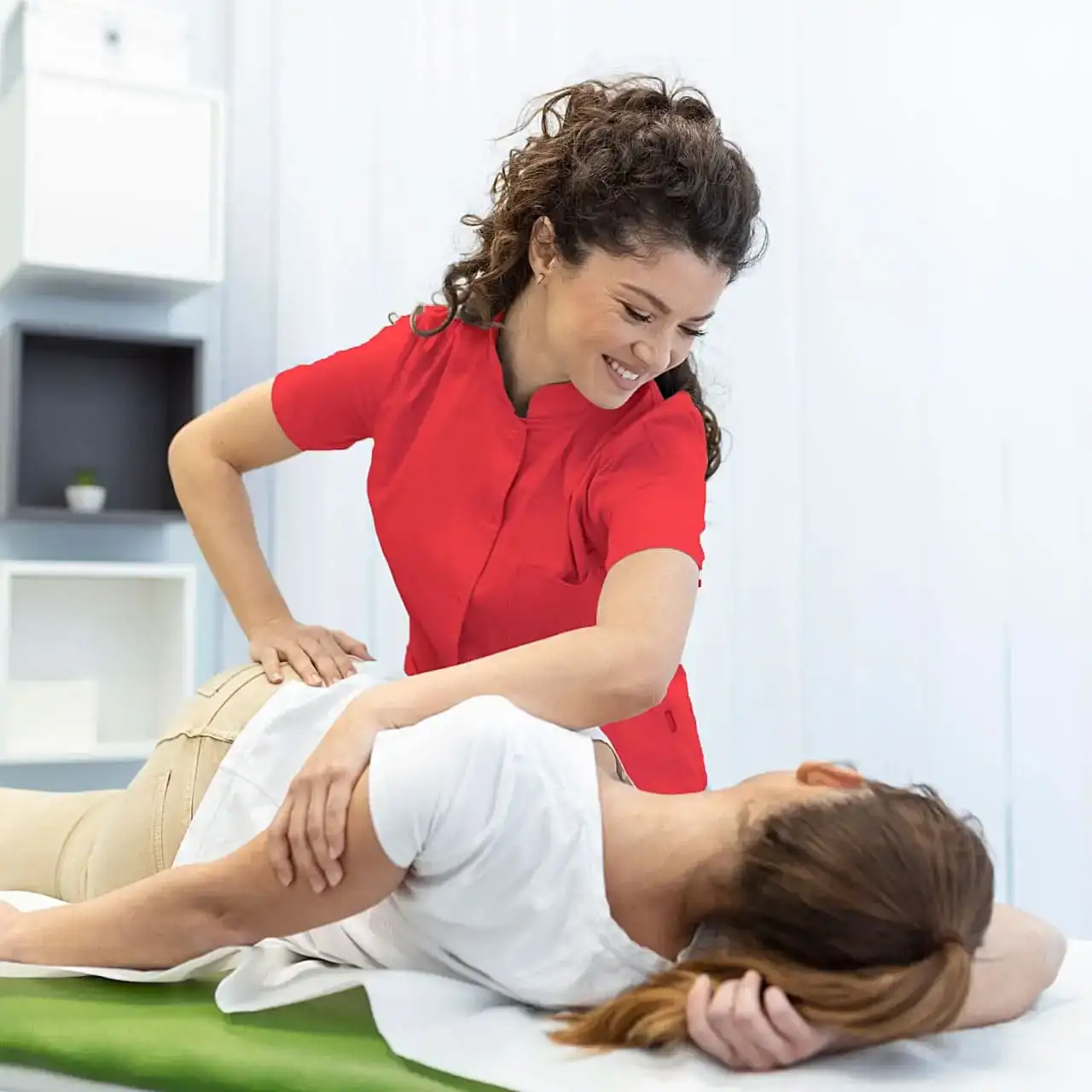 young-woman-doctor-chiropractor-osteopath-fixing-lying-womans-back-with-hands-movements-visit-manual-therapy-clinic-professional-chiropractor-work